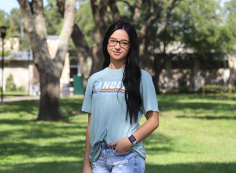 female student standing in the Quad