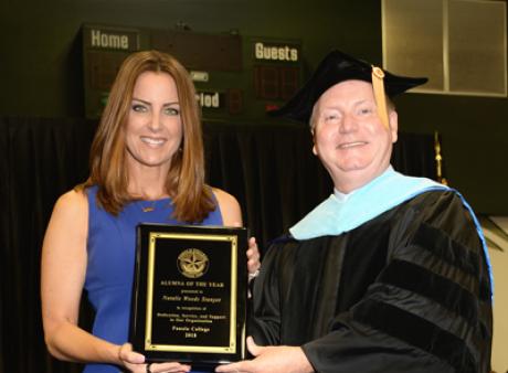 Alumnus of the year and President Powell holding award