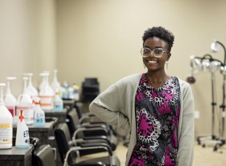 cosmetology student standing by sinks