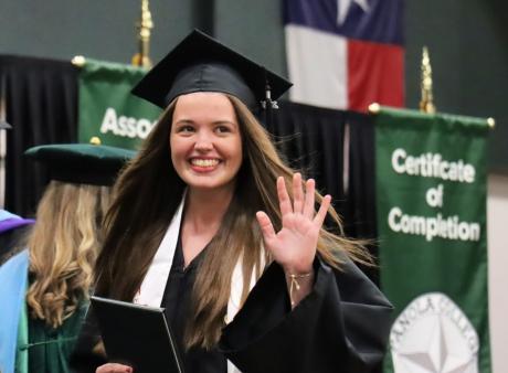 Graduate waving