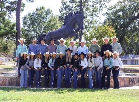 Panola College rodeo team standing infront of the Panola College Pony fountain