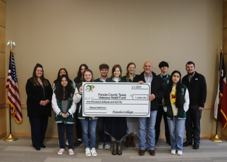 students presenting a check to the veterans relief fund