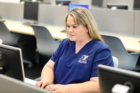 Female HIT Student at computer