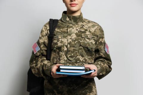 military person carrying books