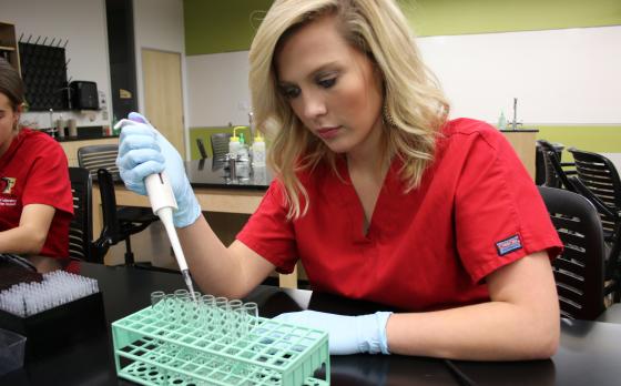 MLT student with test tubes